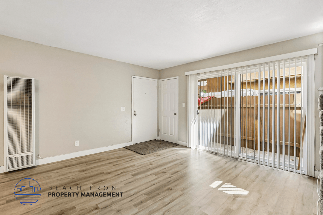 A room with a sliding door leading to a balcony.